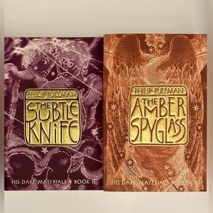 The Golden Compass trilogy by Philip Pullman paperback. Books 2, & 3 only! 💜🧡